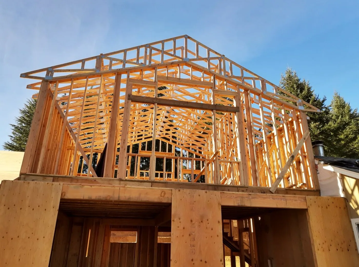 Hillside Garage & ADU — roof trusses and bare framing during the build