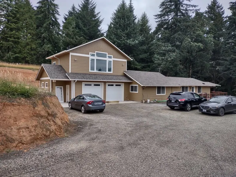 Completed two-story ADU and garage next to the original home, showing the full scope of this Red Umbrella new-construction project.