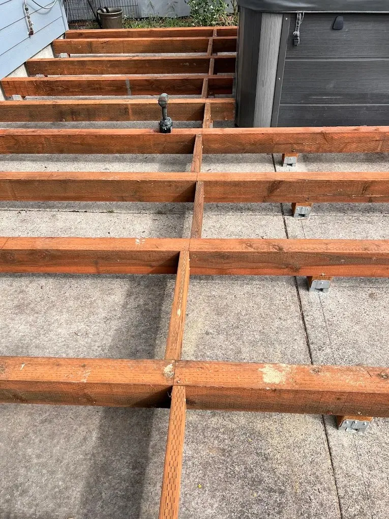 Backyard Cedar Deck — joist framing over the old concrete patio